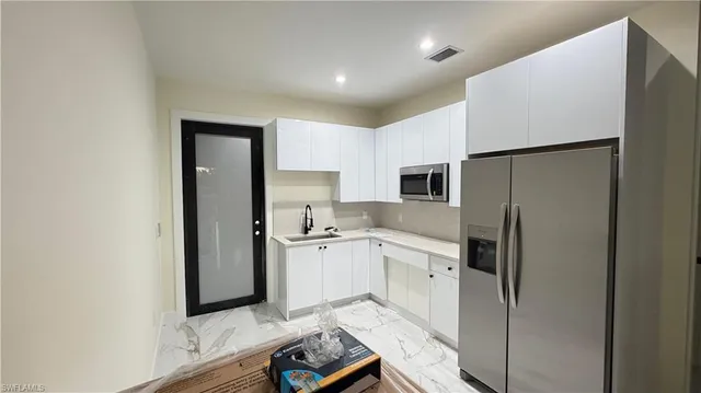 a kitchen with a refrigerator a sink and dishwasher