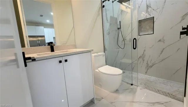 a bathroom with a toilet sink and shower