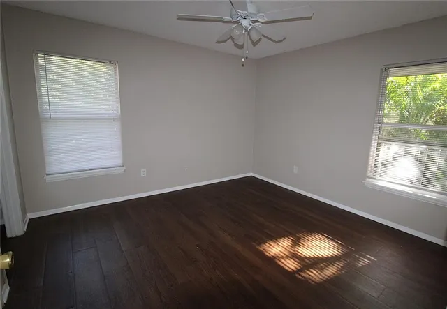 wooden floor in an empty room with a window
