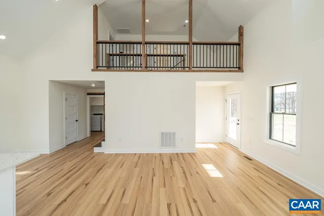 a view of a room with wooden floor