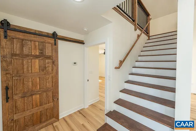 a view of entryway with wooden floor and stairs
