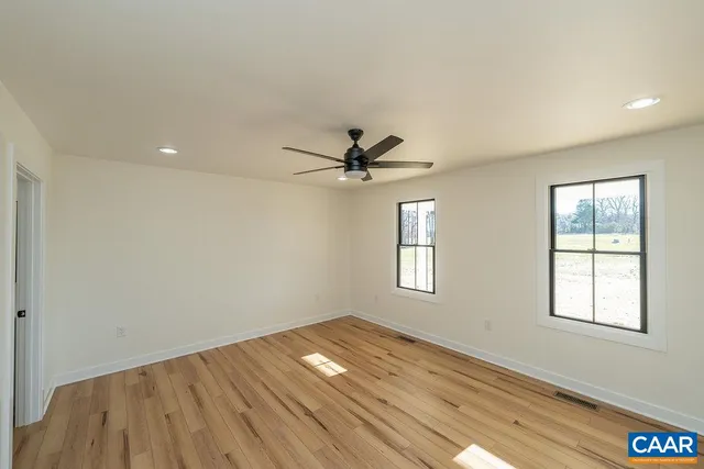 wooden floor in an empty room with a window