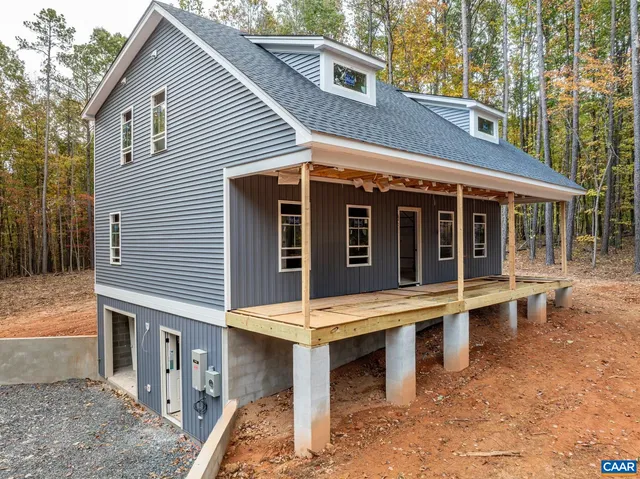 a view of a house with a large window and sitting area