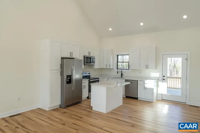 a kitchen with stainless steel appliances a refrigerator sink and stove