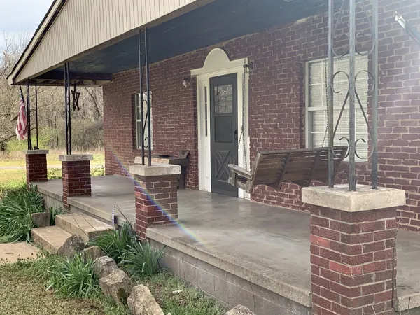 a view of a patio with table and chairs and potted plants