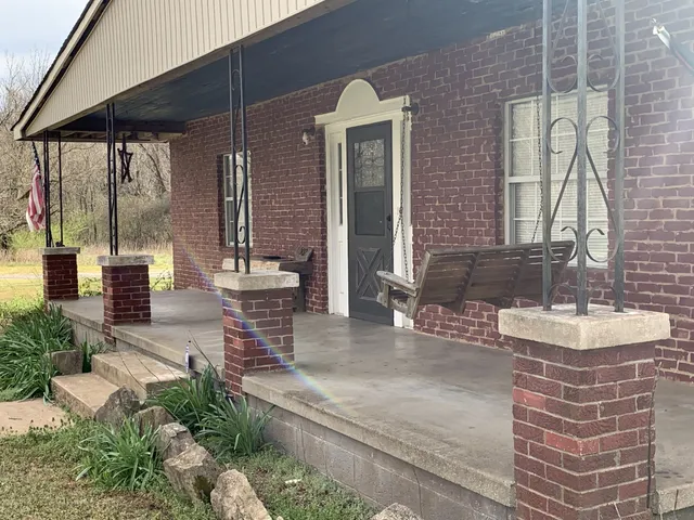 a view of a patio with table and chairs and potted plants
