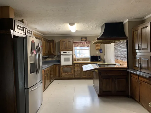 a kitchen with stainless steel appliances a refrigerator and a stove