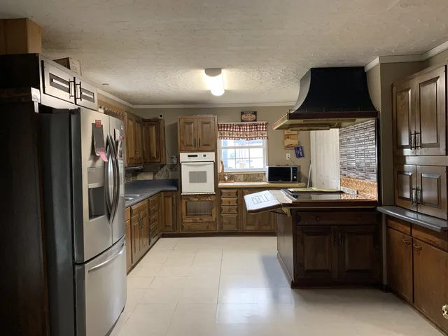 a kitchen with stainless steel appliances a refrigerator and a stove