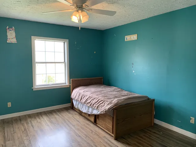 a bedroom with a bed and a window