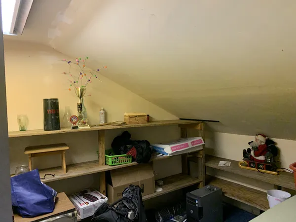 a view of storage and utility room with racks on the wall