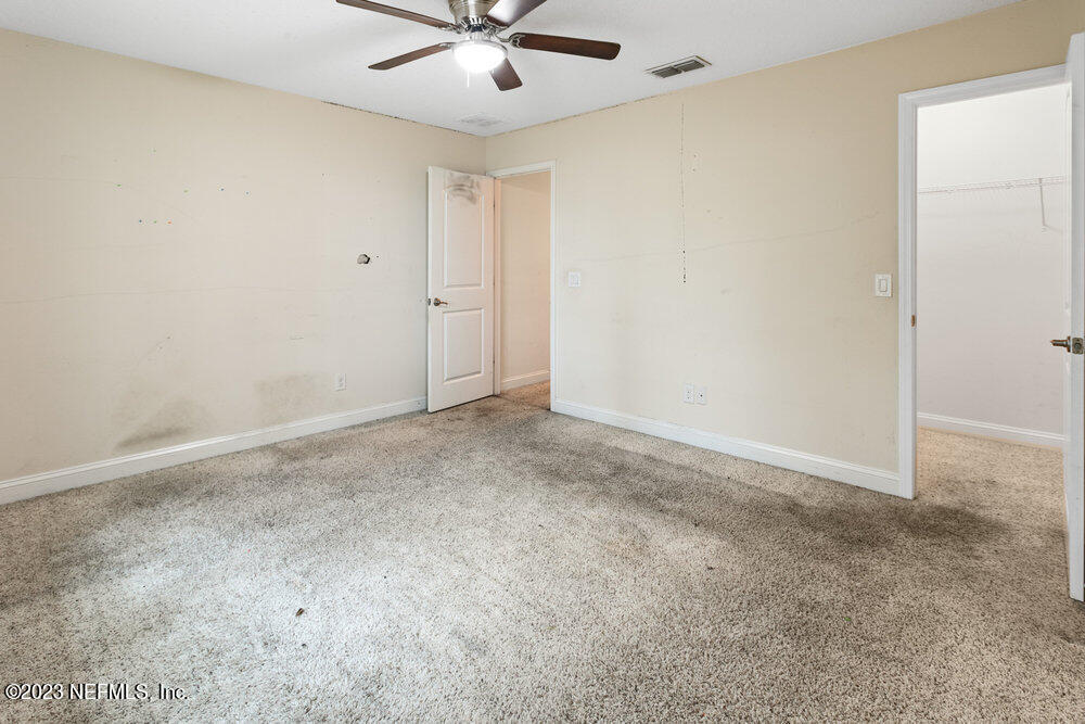 88175 Maybourne Road Yulee, FL 32097 - Photo 29 of 42 an empty room with a fan & a ceiling fan