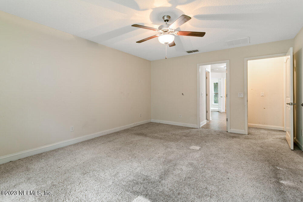 88175 Maybourne Road Yulee, FL 32097 - Photo 32 of 42 an empty room with chandelier fan and window