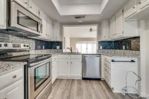 a kitchen with white cabinets stainless steel appliances and sink