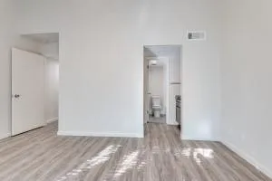 a view of an empty room and wooden floor