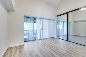 an empty room with wooden floor and a window