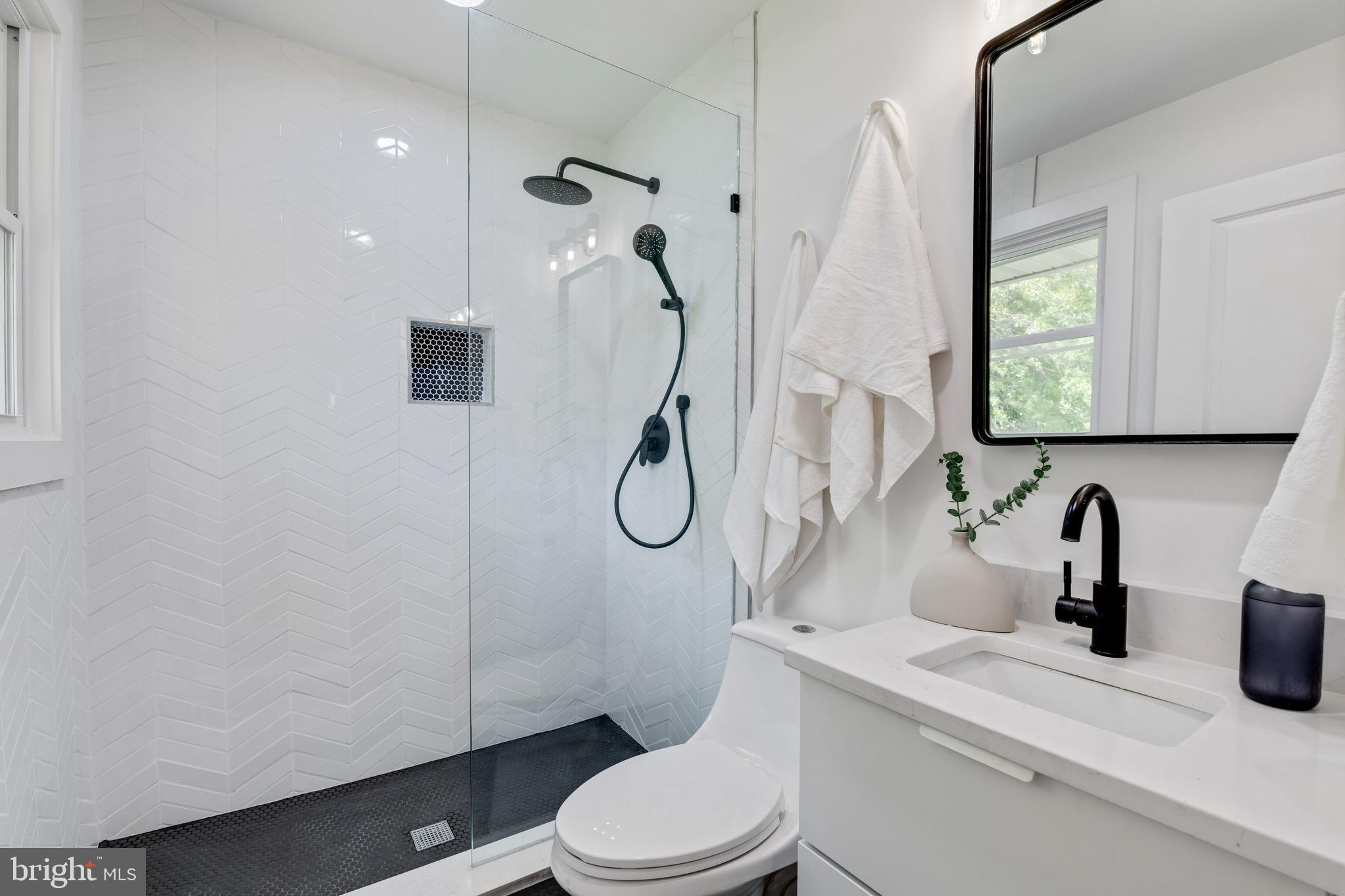 2001 Reuter Road Lutherville-Timonium, MD 21093 - Photo 22 of 38 Owner's Bath with penny & herringbone tile shower