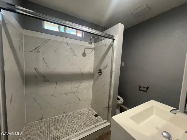 a bathroom with a sink and shower