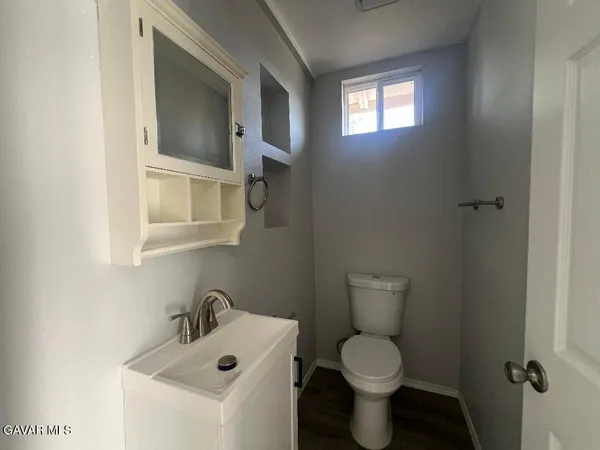 a bathroom with a toilet sink and a mirror
