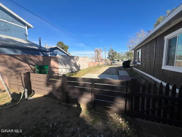 a view of a small space with wooden floor and a window