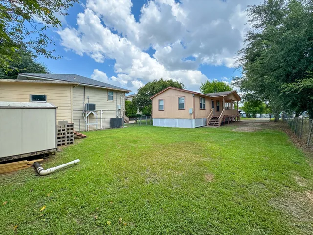 a view of a house with a backyard porch and sitting area