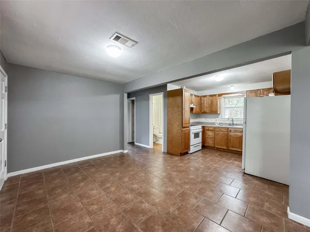 a view of a kitchen with a sink and dishwasher a refrigerator with wooden floor