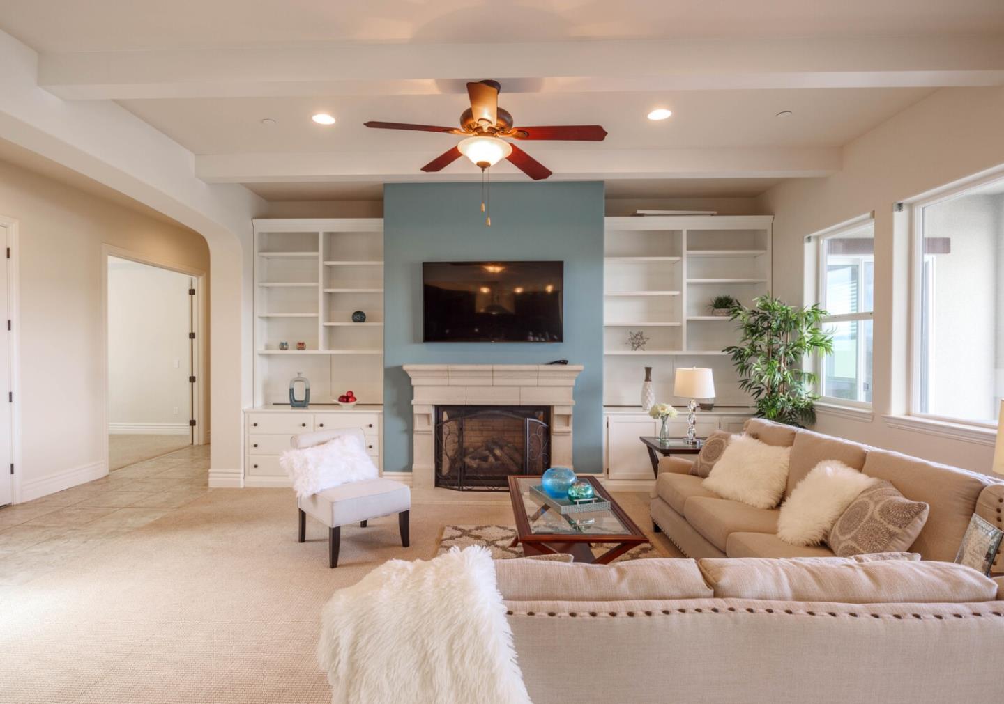 7230 Pitlochry Drive Gilroy, CA 95020 - Photo 15 of 74 a living room with furniture a fireplace and a flat screen tv