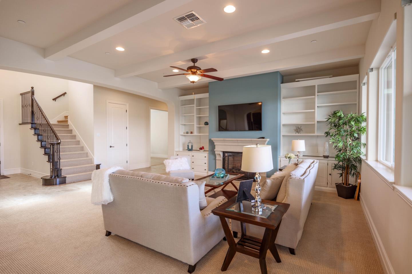 7230 Pitlochry Drive Gilroy, CA 95020 - Photo 16 of 74 a living room with furniture a fireplace and a flat screen tv
