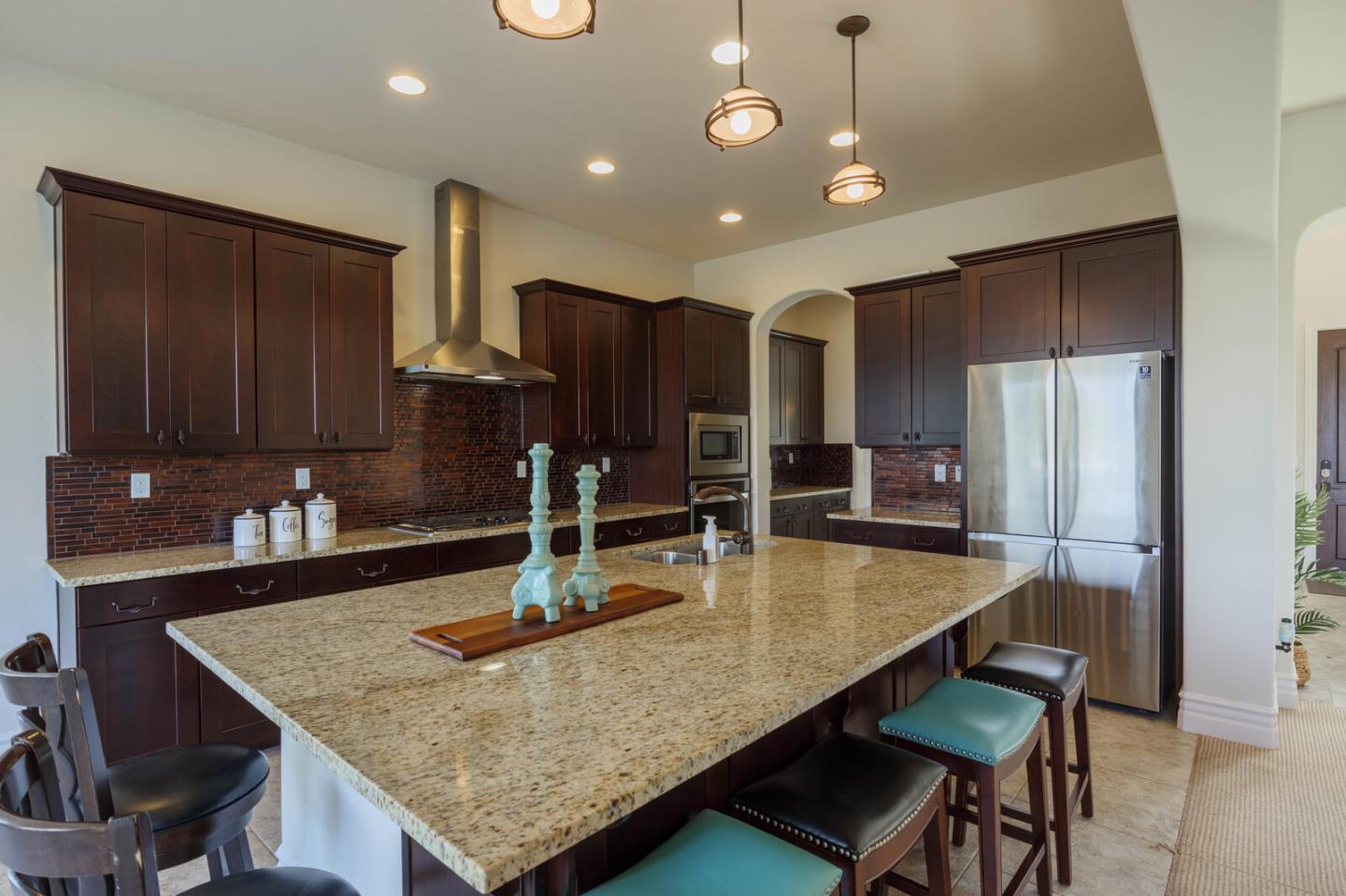 7230 Pitlochry Drive Gilroy, CA 95020 - Photo 18 of 74 a kitchen with kitchen island a counter top space cabinets and stainless steel appliances