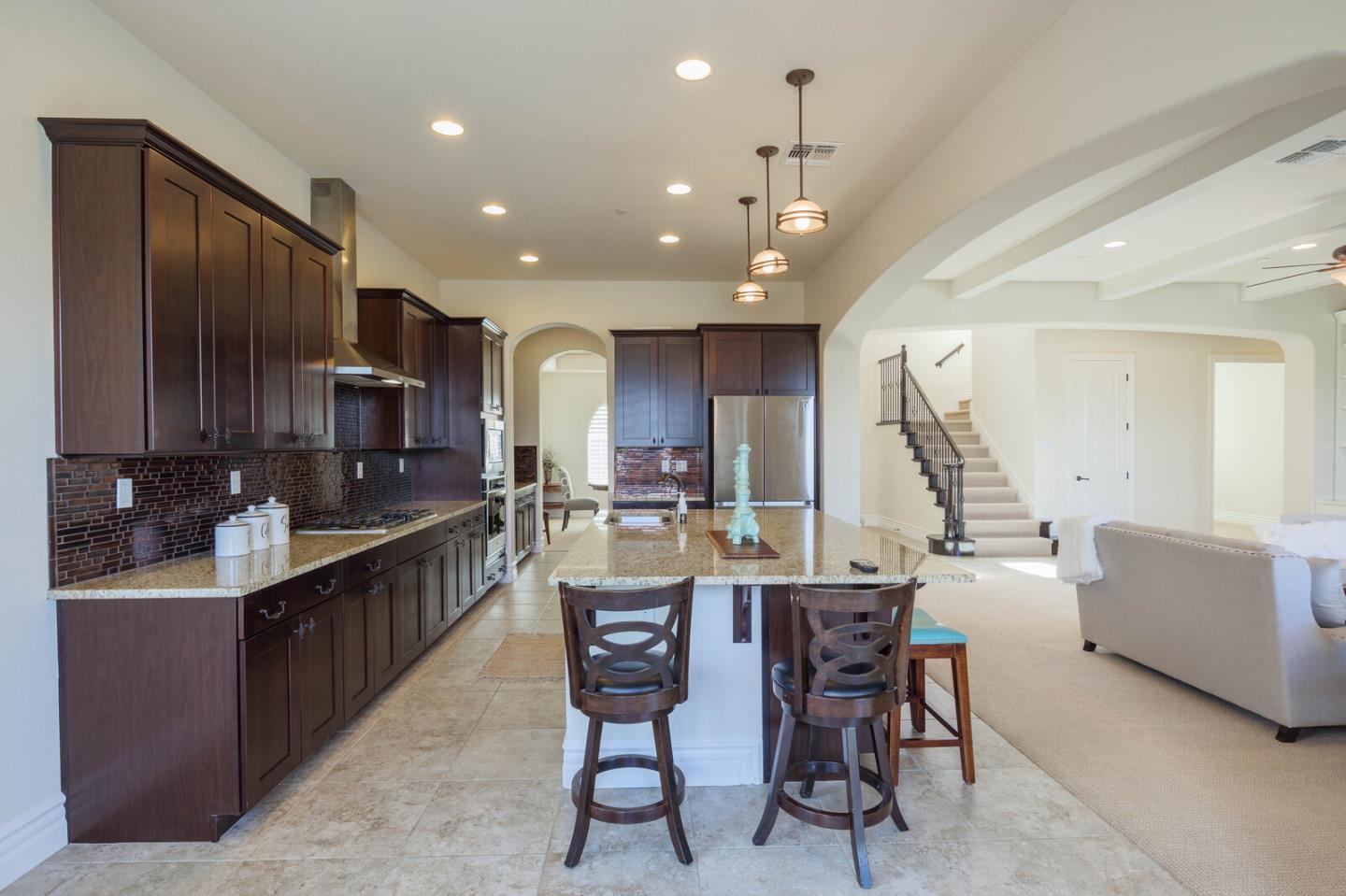 7230 Pitlochry Drive Gilroy, CA 95020 - Photo 19 of 74 a kitchen with stainless steel appliances kitchen island granite countertop a sink and cabinets