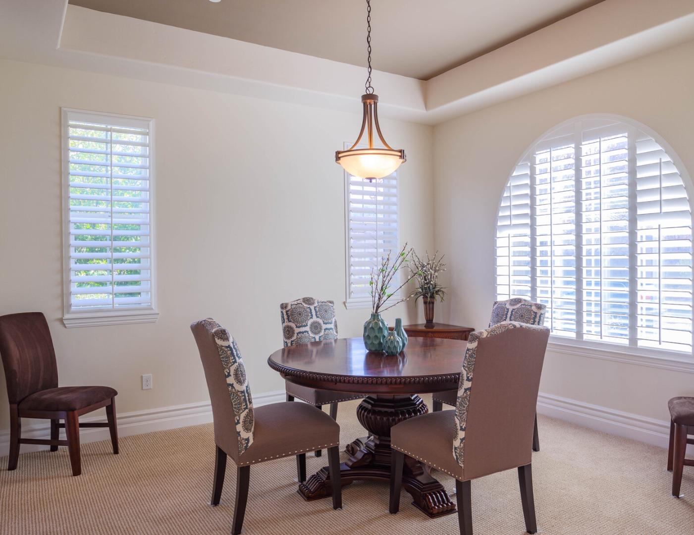 7230 Pitlochry Drive Gilroy, CA 95020 - Photo 25 of 74 a dining room with furniture a chandelier and wooden floor