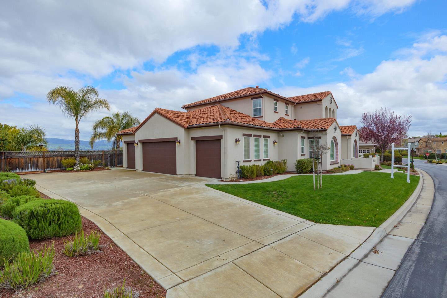 7230 Pitlochry Drive Gilroy, CA 95020 - Photo 4 of 74 a front view of a house with a garden and plants