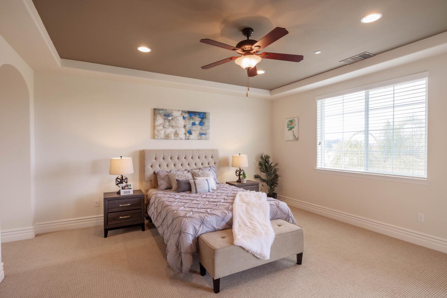 7230 Pitlochry Drive Gilroy, CA 95020 - Photo 45 of 74 a spacious bedroom with a large bed and a chandelier