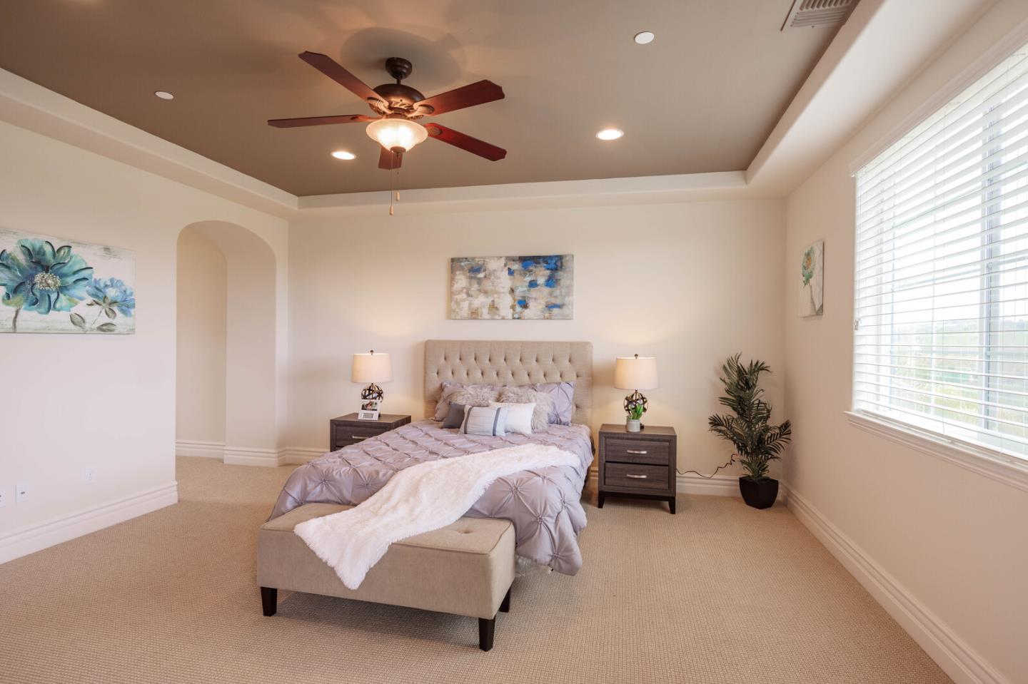 7230 Pitlochry Drive Gilroy, CA 95020 - Photo 47 of 74 a spacious bedroom with a bed and a chandelier
