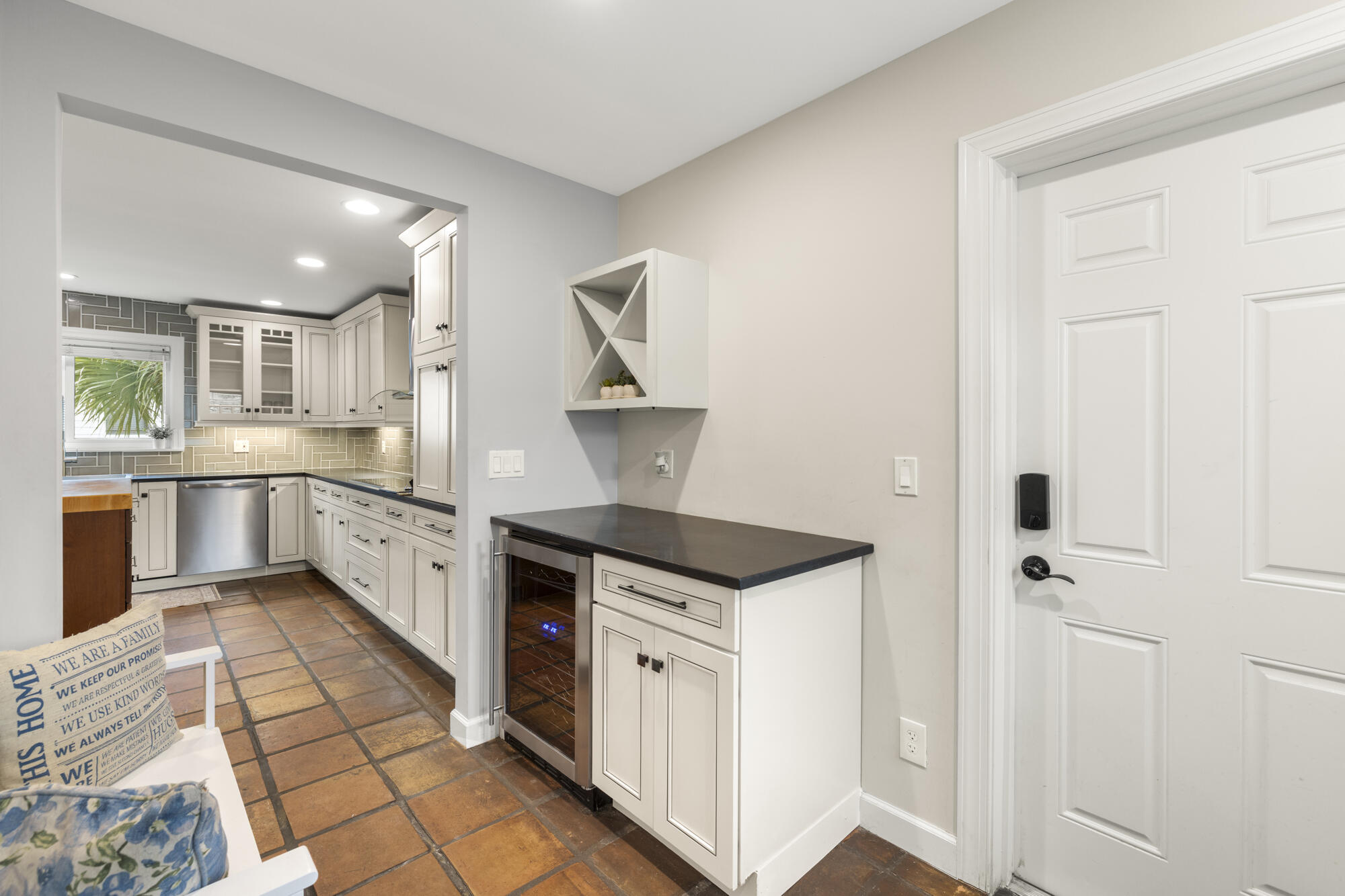 6595 Wood Lake Road Jupiter, FL 33458 - Photo 13 of 54 a kitchen with white cabinets and appliances