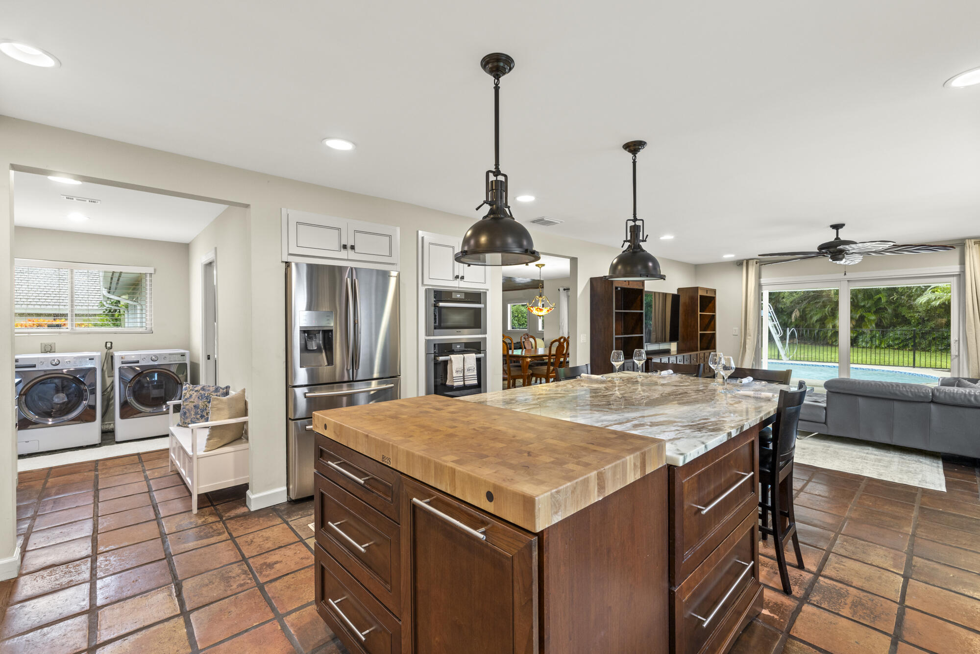 6595 Wood Lake Road Jupiter, FL 33458 - Photo 19 of 54 a kitchen with a stove a sink and a refrigerator