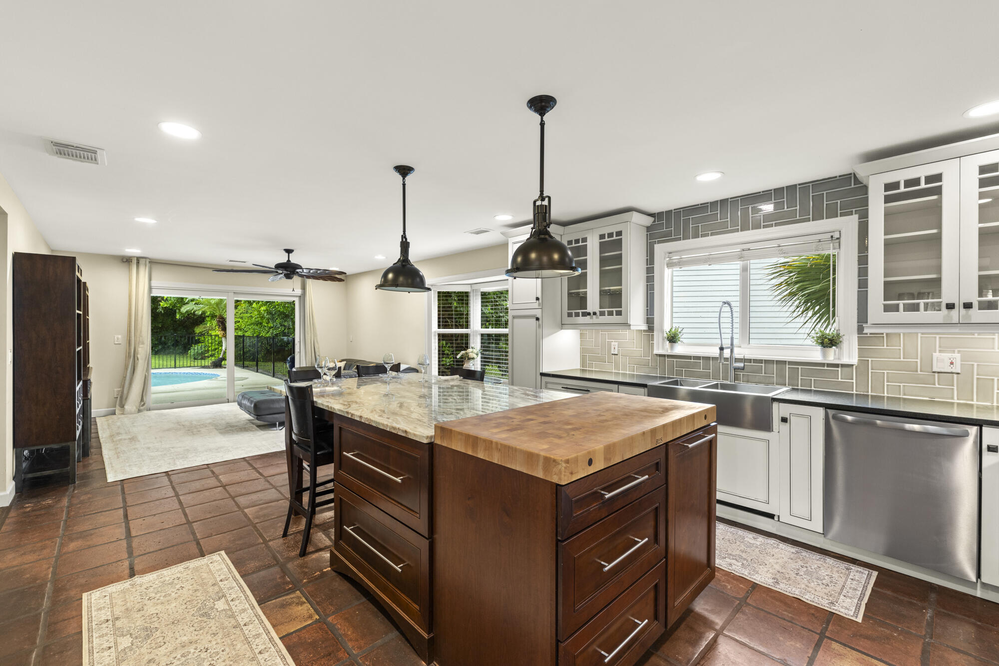 6595 Wood Lake Road Jupiter, FL 33458 - Photo 20 of 54 a kitchen with a stove a sink and a wooden floors
