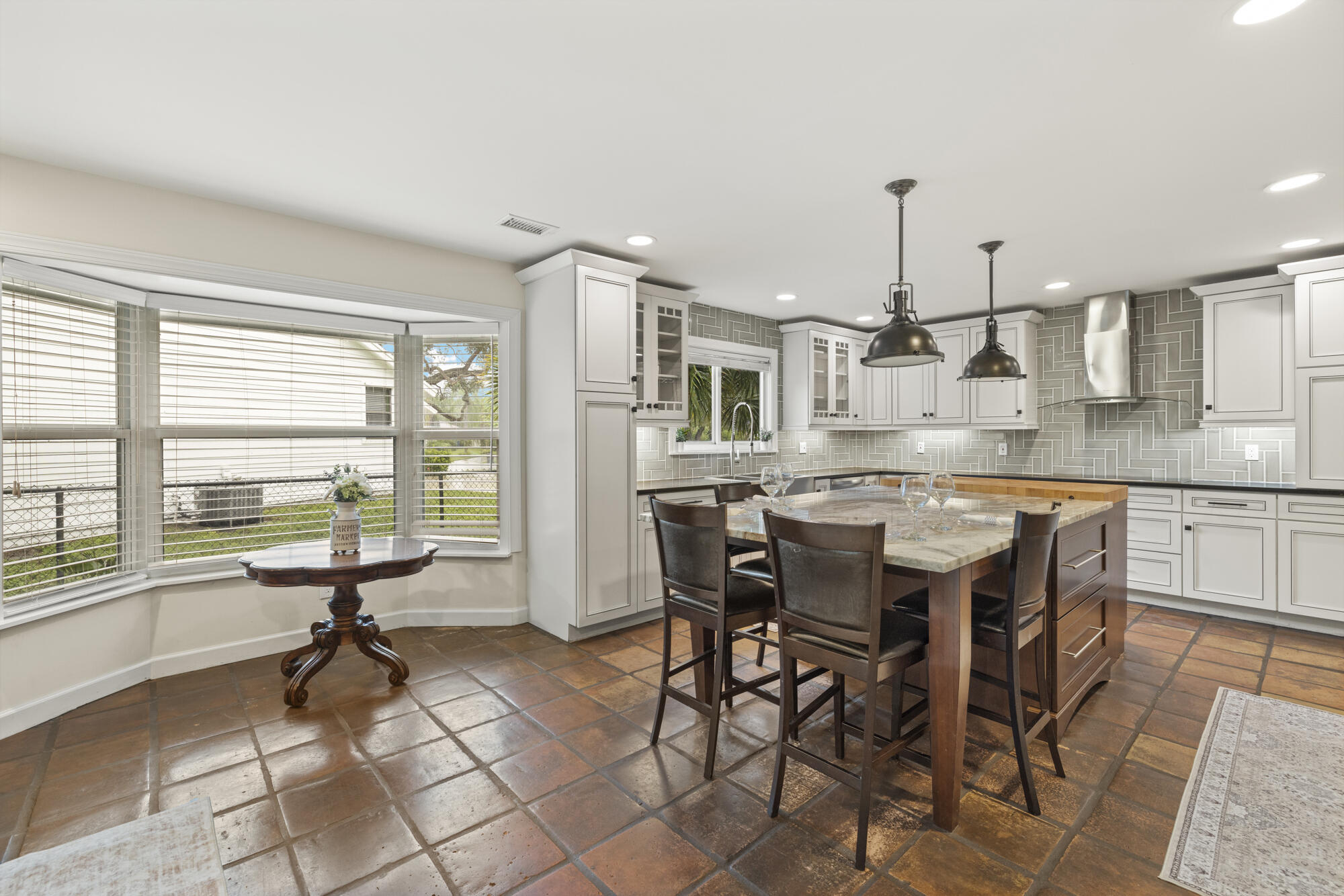 6595 Wood Lake Road Jupiter, FL 33458 - Photo 22 of 54 a view of a dining room kitchen and windows
