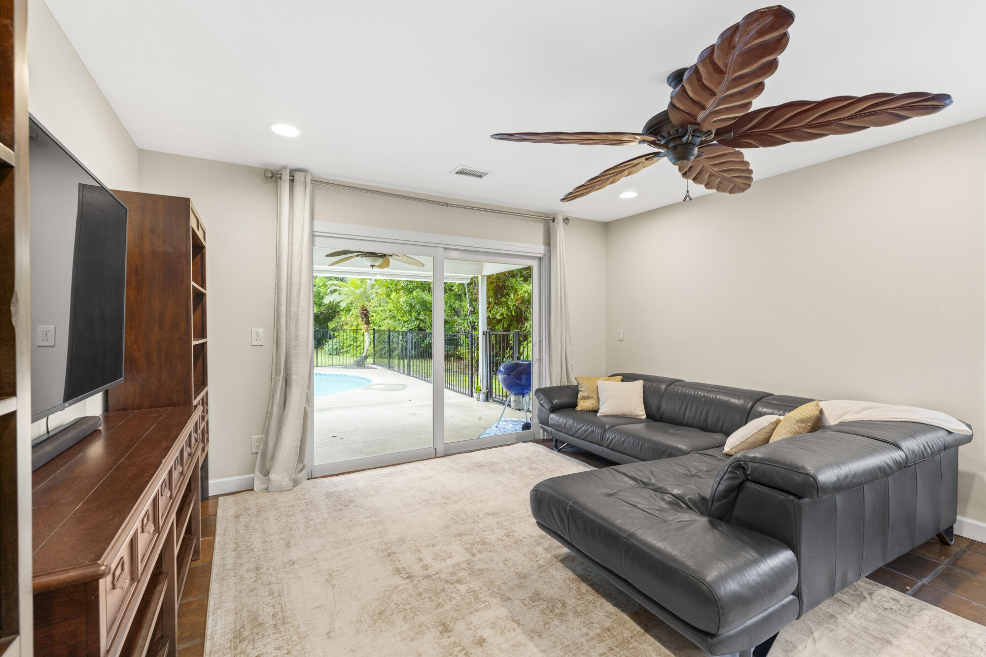 6595 Wood Lake Road Jupiter, FL 33458 - Photo 24 of 54 a living room with furniture and a flat screen tv