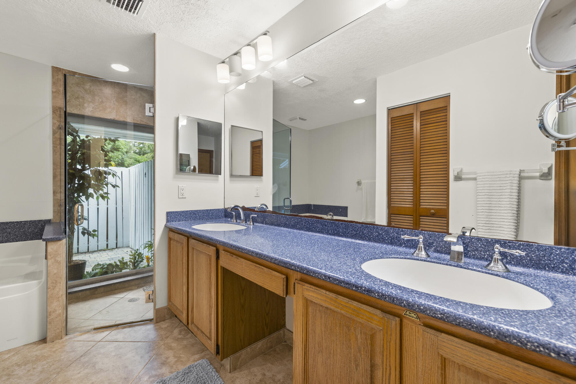 6595 Wood Lake Road Jupiter, FL 33458 - Photo 30 of 54 a bathroom with a granite countertop sink and a mirror