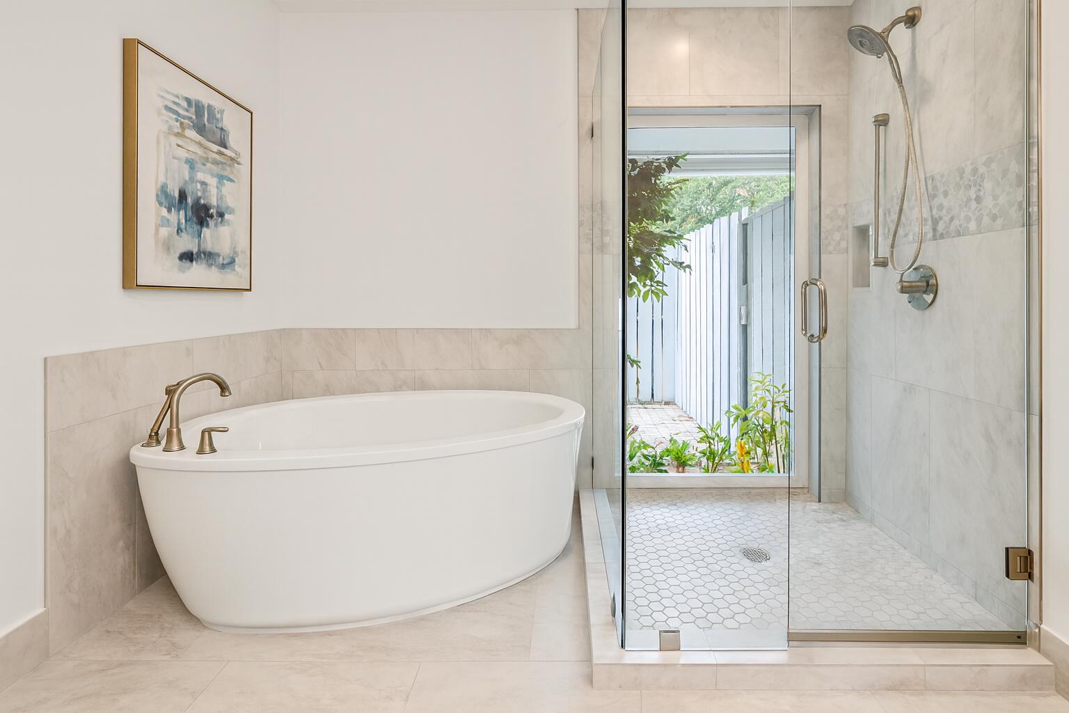 6595 Wood Lake Road Jupiter, FL 33458 - Photo 33 of 54 a white bath tub sitting in a bathroom next to a window