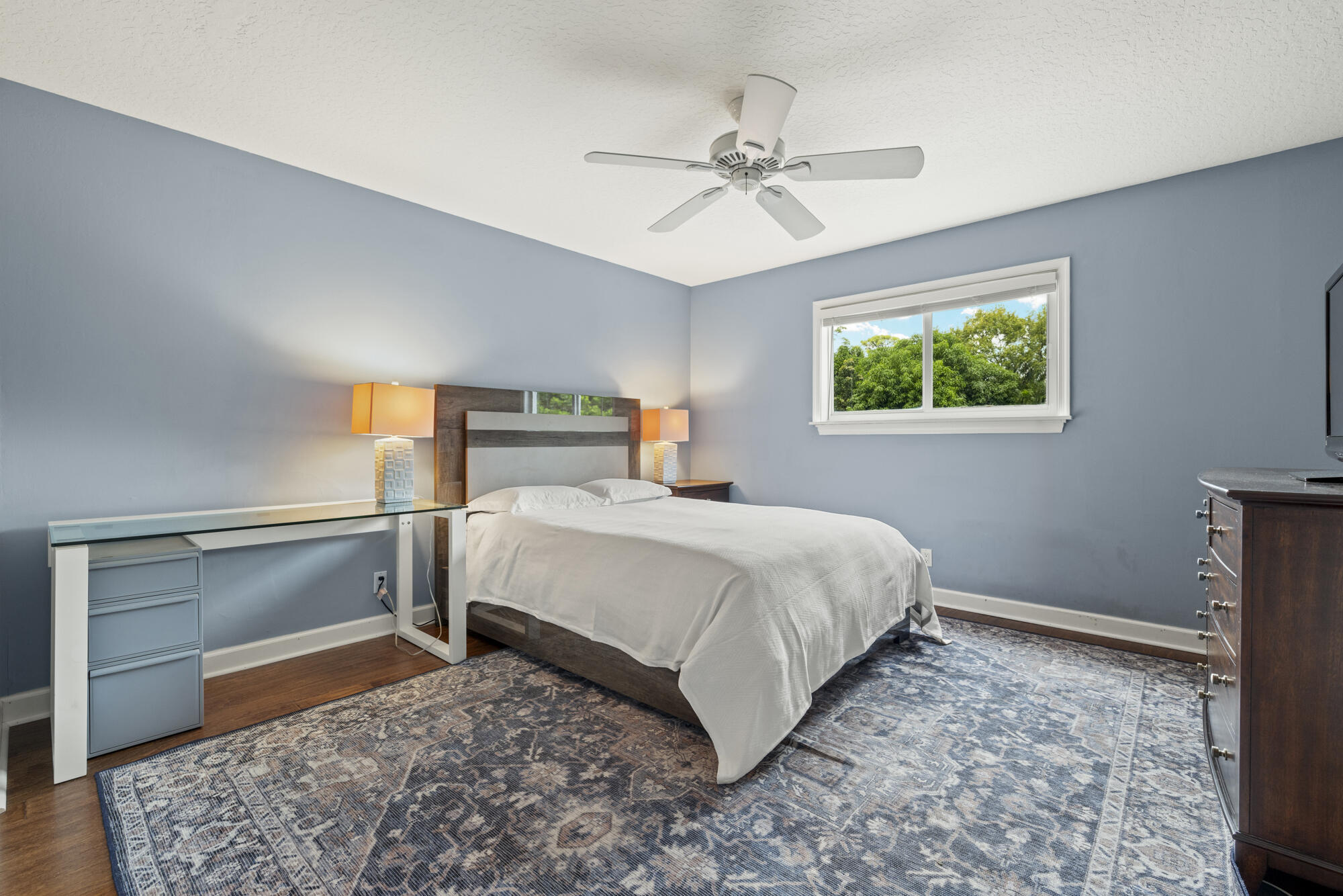 6595 Wood Lake Road Jupiter, FL 33458 - Photo 34 of 54 a bedroom with a bed and a painting on the wall