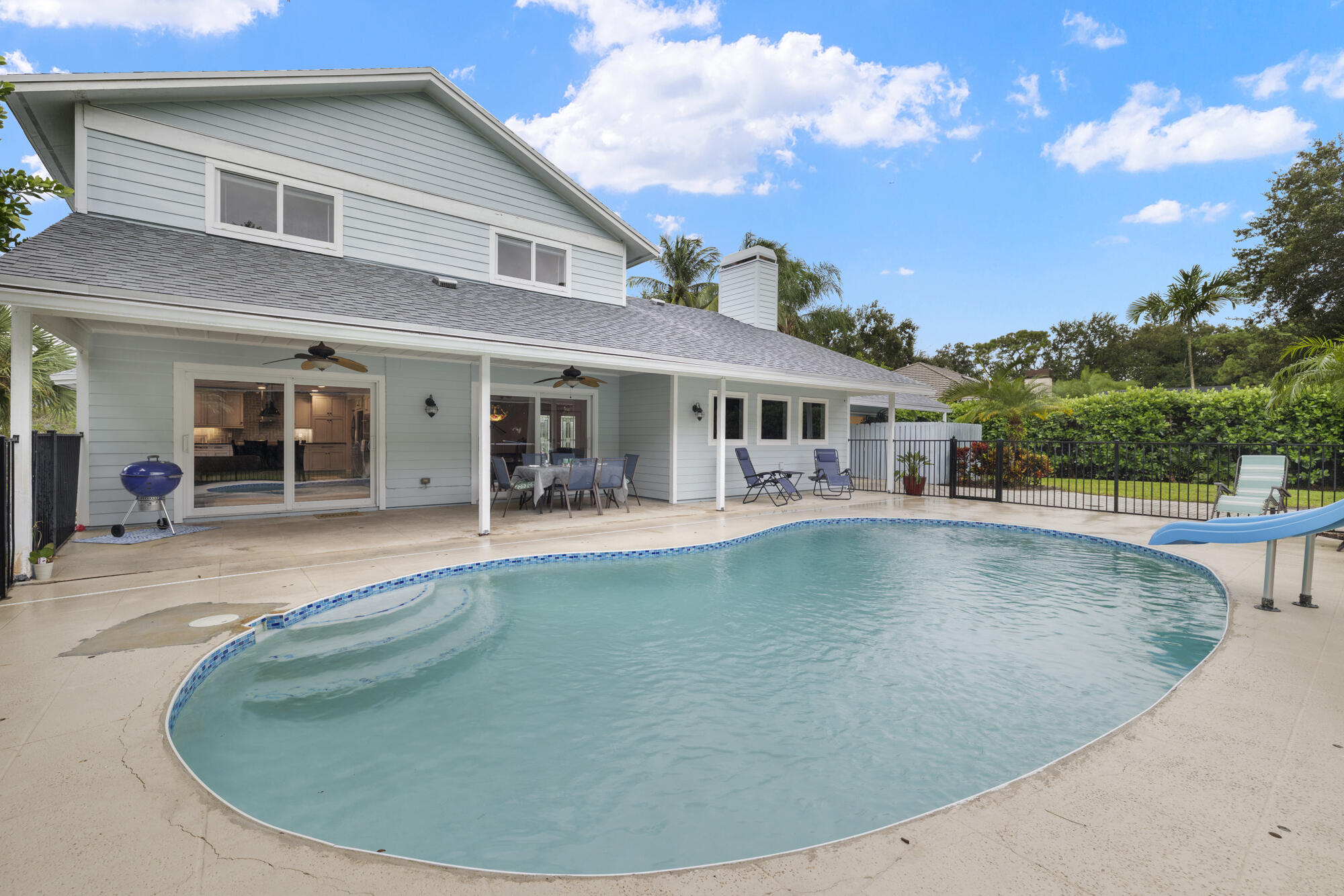 6595 Wood Lake Road Jupiter, FL 33458 - Photo 41 of 54 a view of a house with swimming pool