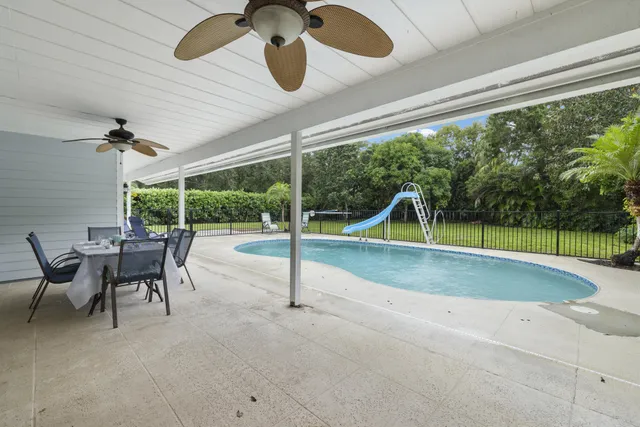 a view of a swimming pool with a patio