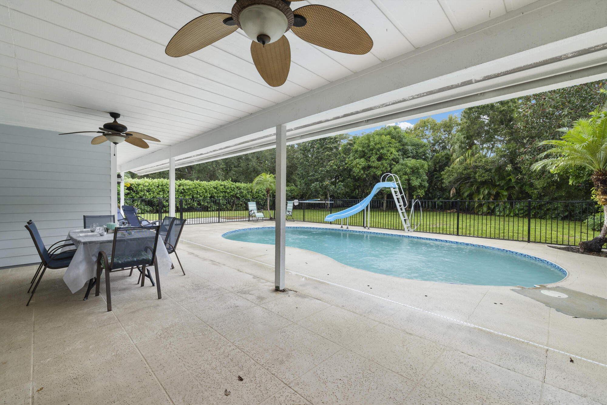 6595 Wood Lake Road Jupiter, FL 33458 - Photo 42 of 54 a view of a swimming pool with a patio