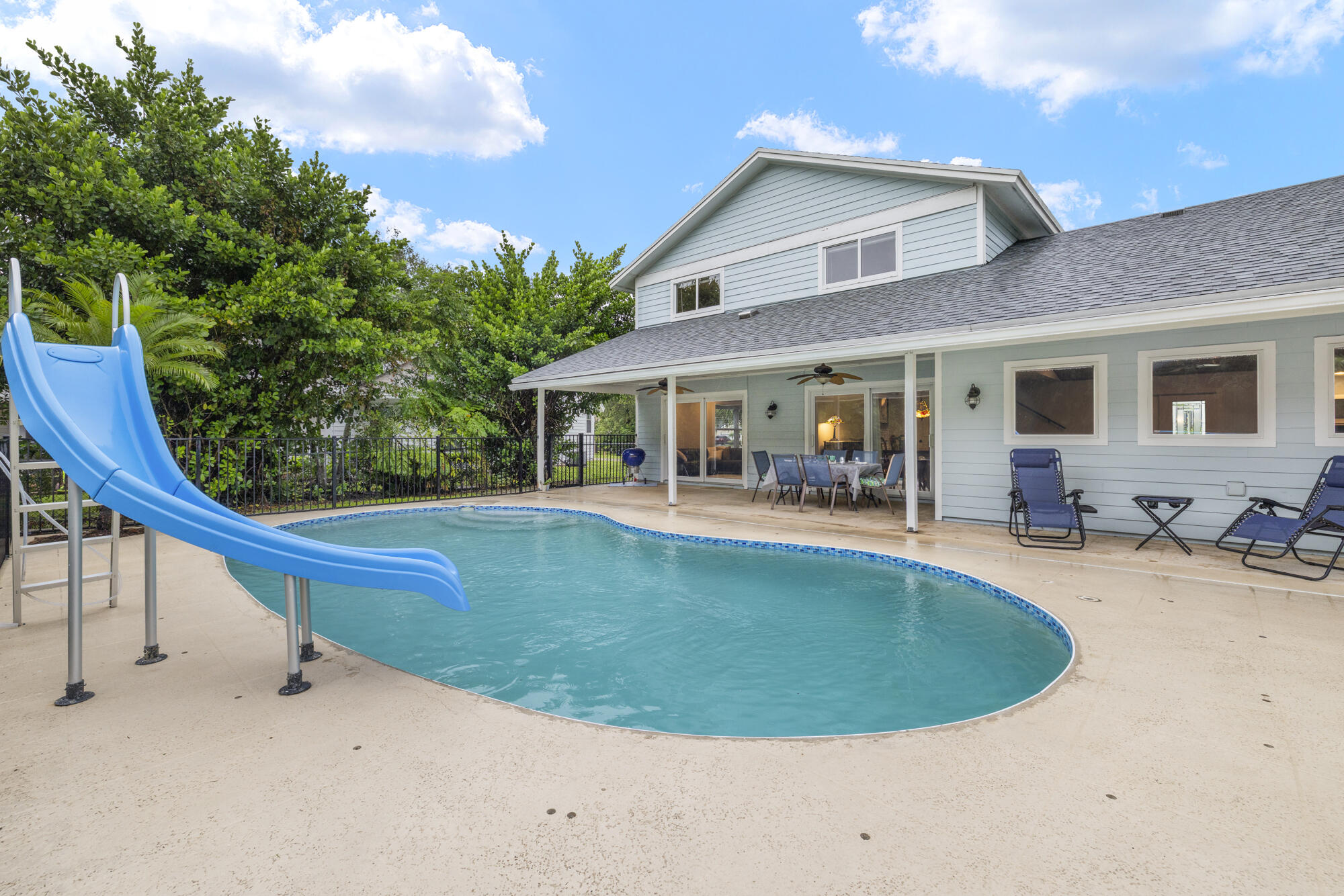 6595 Wood Lake Road Jupiter, FL 33458 - Photo 43 of 54 a view of a house with swimming pool and sitting area
