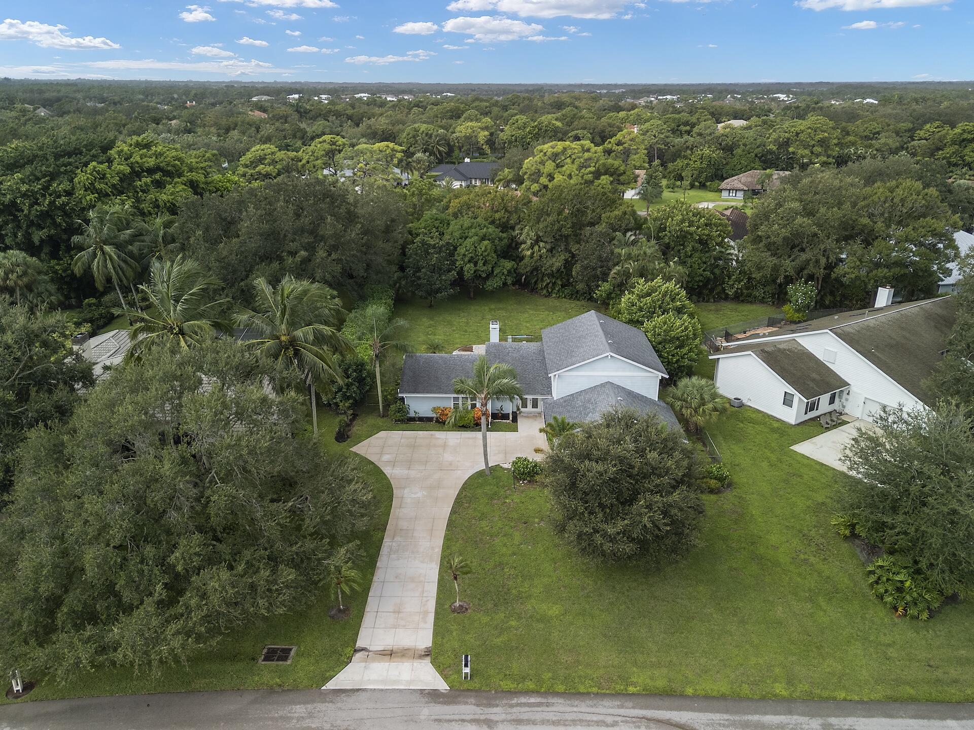 6595 Wood Lake Road Jupiter, FL 33458 - Photo 47 of 54 an aerial view of a house with a yard