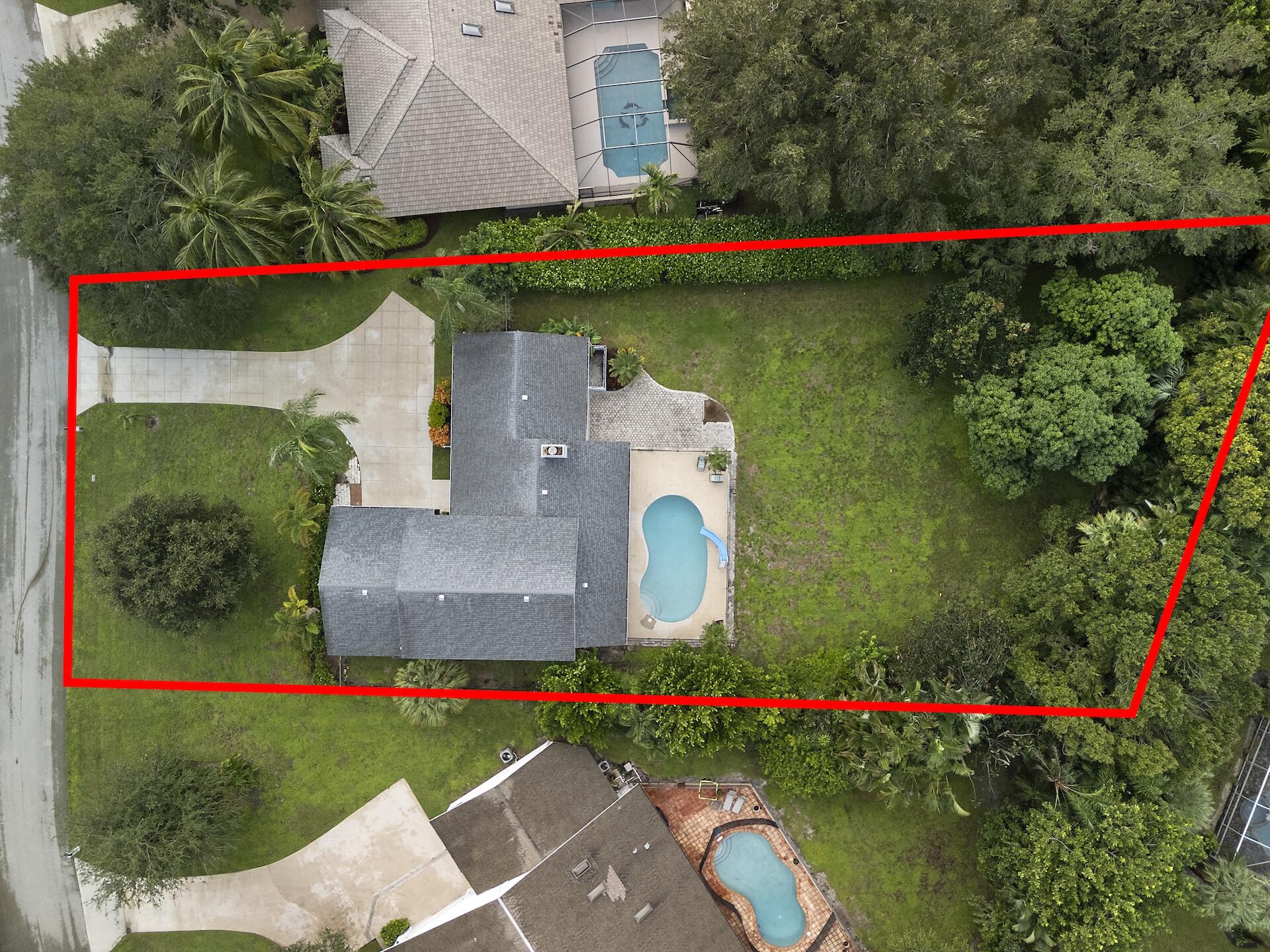 6595 Wood Lake Road Jupiter, FL 33458 - Photo 49 of 54 a garden view with a play ground and painted walls