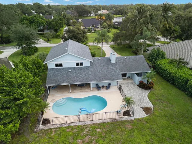 an aerial view of a house with swimming pool garden and mountain view