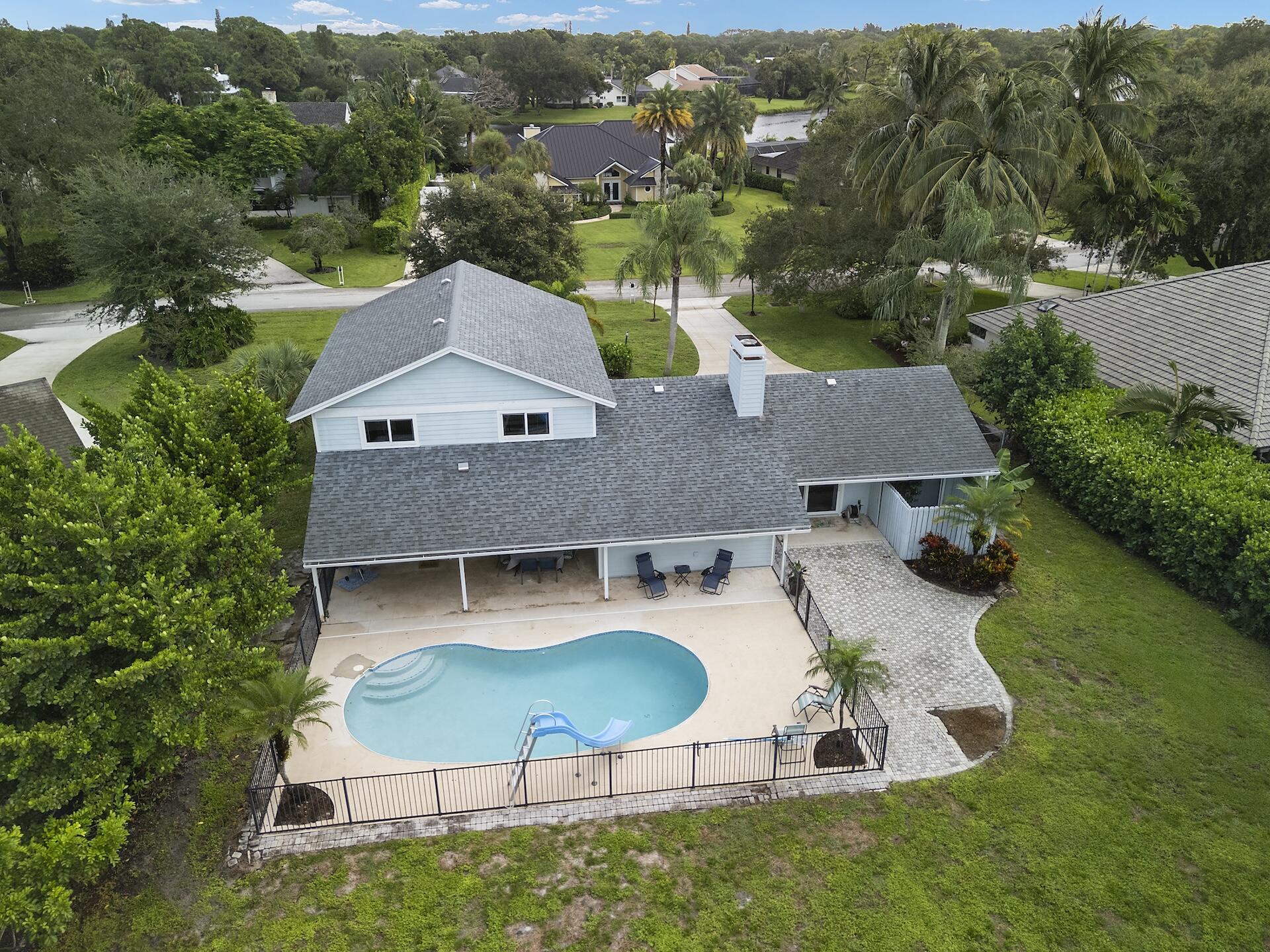 6595 Wood Lake Road Jupiter, FL 33458 - Photo 50 of 54 an aerial view of a house with swimming pool garden and mountain view