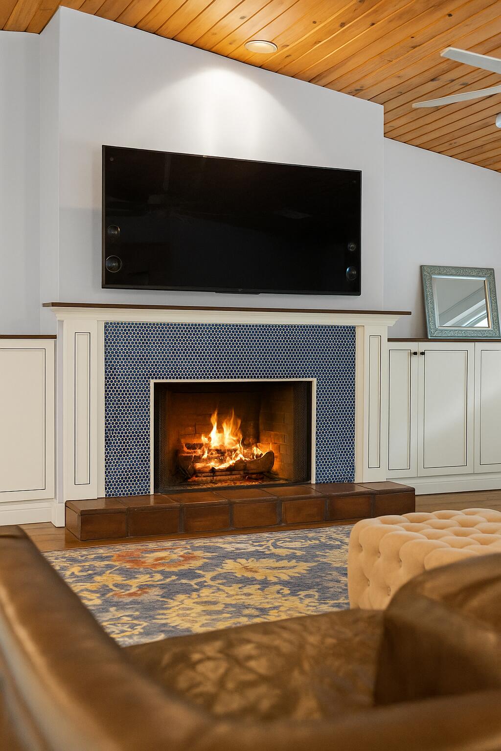6595 Wood Lake Road Jupiter, FL 33458 - Photo 8 of 54 a living room with a fireplace and a flat screen tv